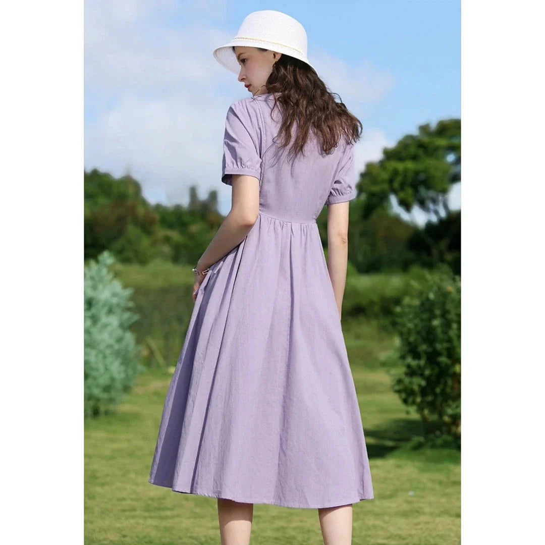 Sophisticated French-inspired short sleeve summer dress with puff sleeves, turn-down collar, and lace-up detailing