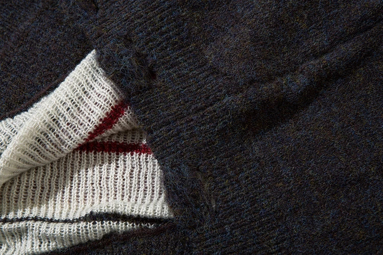 A cosy and stylish jumper featuring a patchwork design with contrasting stripes in a classic British colour palette.