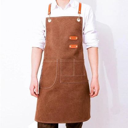 Premium canvas barista apron with British-inspired design, perfect for protecting clothing while crafting coffee.