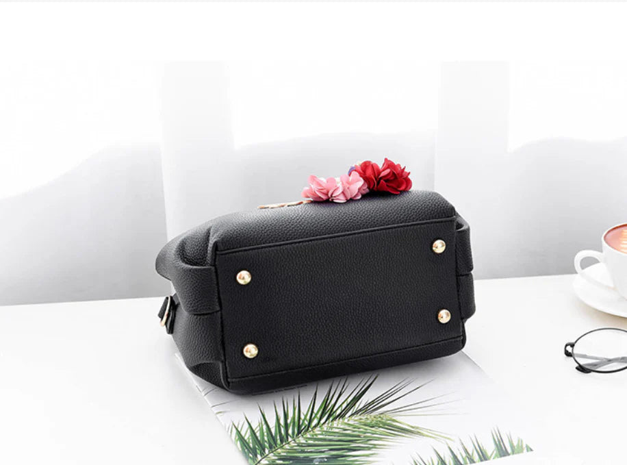 Elegant leather tote bag with delicate flower embellishments, perfect for modern British fashion