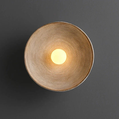 Elegant round wall light fixture with minimalist Wabi Sabi design, providing warm LED illumination for bedrooms and corridors