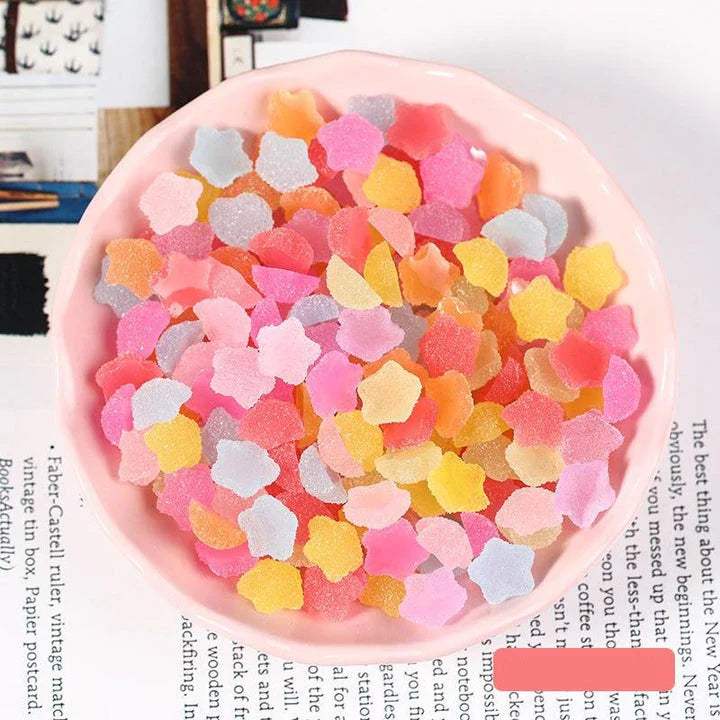 Heart and star-shaped nail charms with candy-inspired designs for creating unique and eye-catching nail art