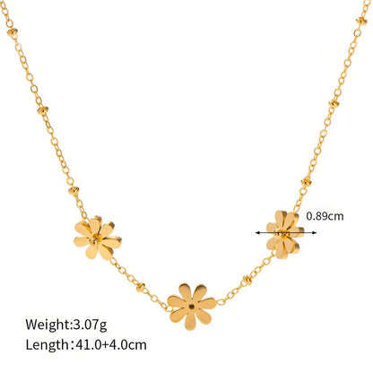 Exquisite 18-carat gold-plated necklace featuring three delicate daisy pendants on a stainless steel chain, embodying timeless British elegance and sophistication.