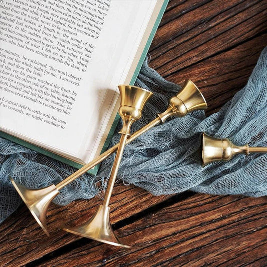 Elegant brass gold candlestick holder set with varying heights, perfect for enhancing the ambiance of any room in the home.