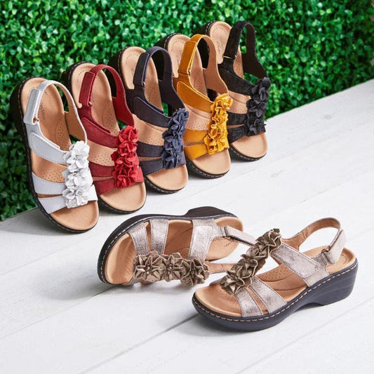 Stylish wedge sandals in a range of vibrant colours, featuring a chic fish mouth design and delicate flower accents for a modern, casual-chic look.