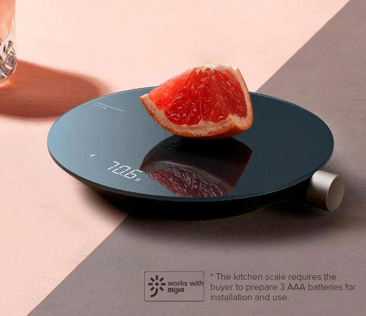 A sleek, stainless steel digital kitchen scale with a vibrant LED display, showcasing precise weighing capabilities up to 5 kilograms.
