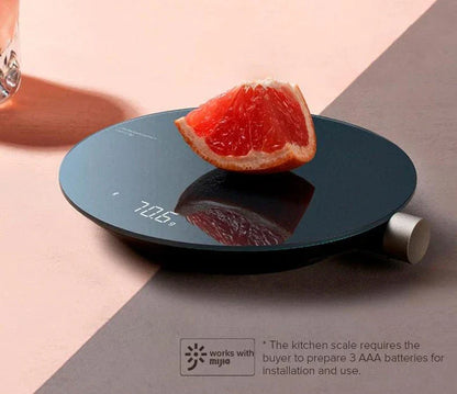 A sleek, stainless steel digital kitchen scale with a vibrant LED display, showcasing precise weighing capabilities up to 5 kilograms.