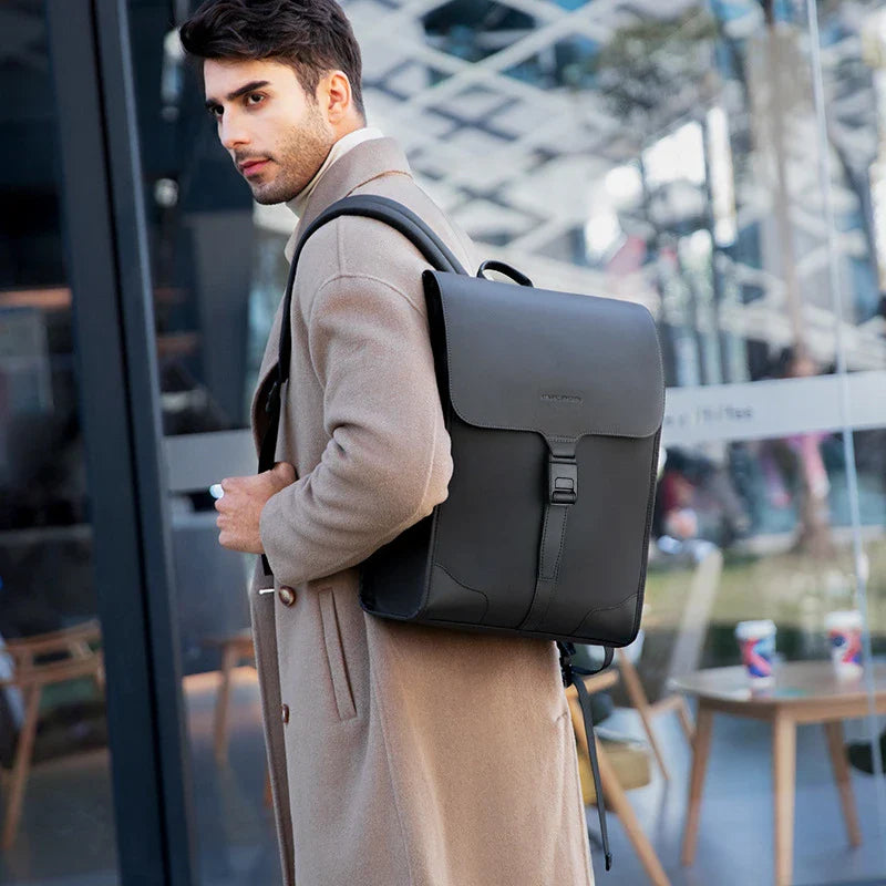 Stylish magnetic buckle laptop backpack for men, featuring a sleek design, spacious interior, and durable PU leather construction.