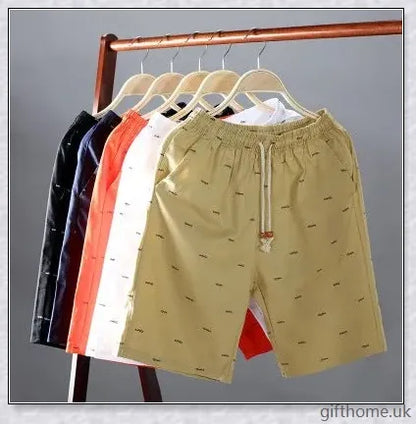 Pair of premium cotton beach shorts in navy blue, khaki, and slate grey colours, perfect for stylish seaside adventures