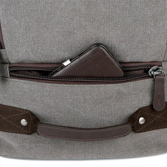 A classic messenger bag made of durable canvas with genuine leather trim, offering style and function for the modern British gentleman