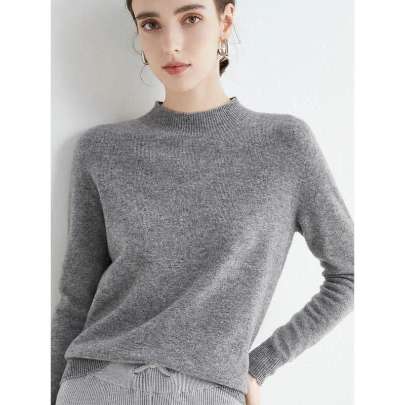 A woman wearing a luxurious Merino wool mock-neck jumper in a stylish autumnal outfit