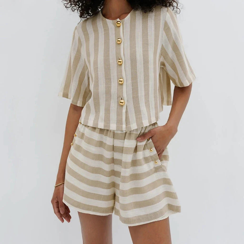 Relaxed and stylish two-piece summer outfit with a striped pattern, featuring a short-sleeved shirt and high-waist shorts.