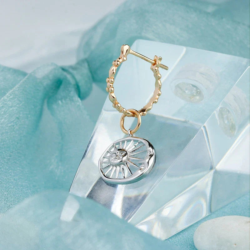 Elegant sterling silver sun and moon earrings with a refined geometric design