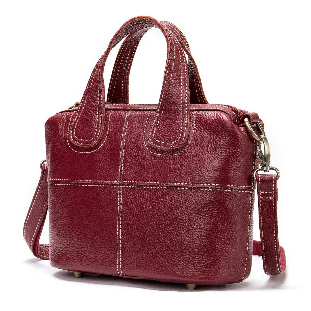 Premium leather shoulder bag for women in red, blue, and black colours with spacious interior and comfortable strap