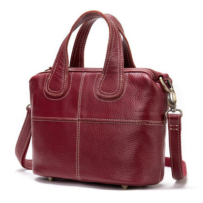 Premium leather shoulder bag for women in red, blue, and black colours with spacious interior and comfortable strap