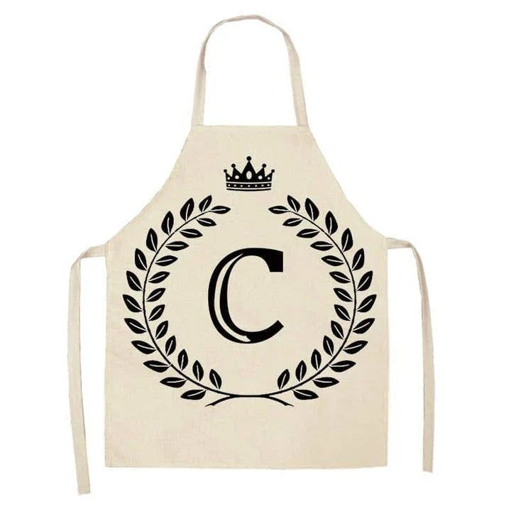 A high-quality kitchen apron featuring a charming crown and letter print design in a premium cotton and linen blend fabric.