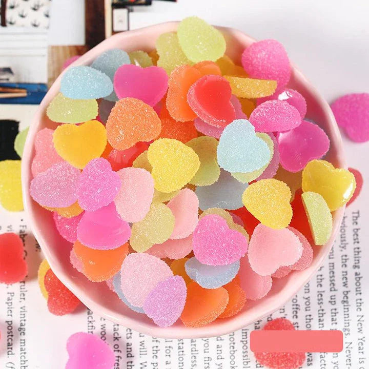 Heart and star-shaped nail charms with candy-inspired designs for creating unique and eye-catching nail art