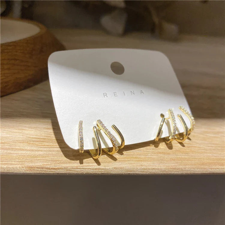 Exquisite zircon four-claw stud earrings in a gleaming gold colour, showcasing a timeless and elegant design