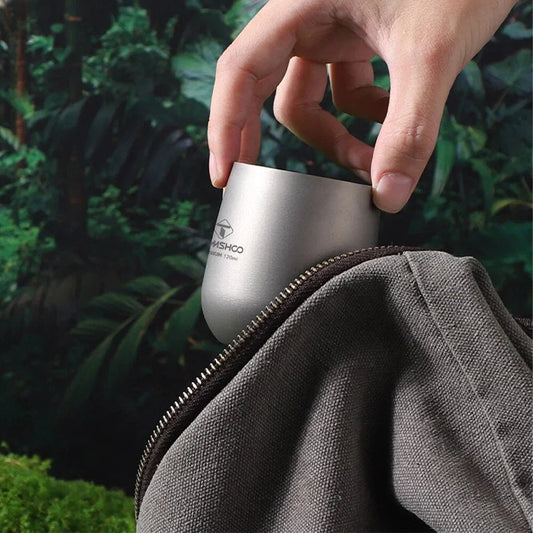 Robust and insulated titanium camping mug with double-wall design for maintaining optimal temperature of hot and cold beverages during outdoor activities