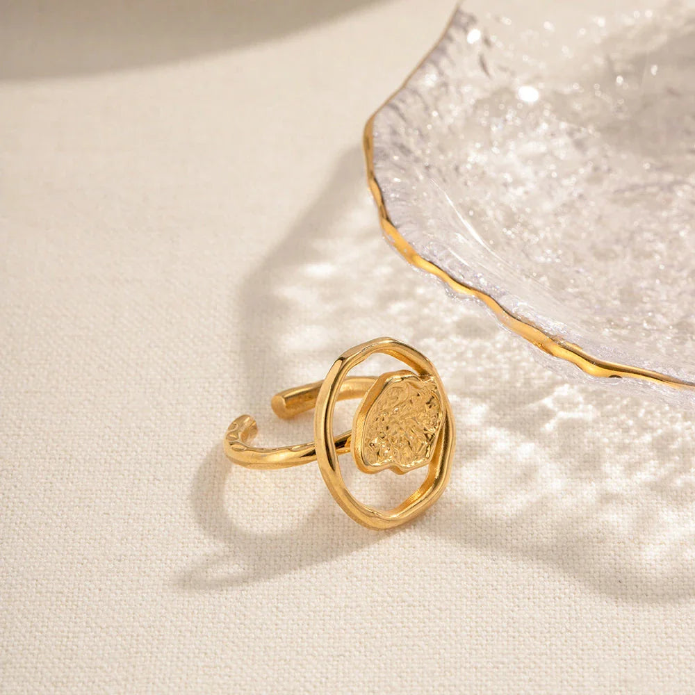 Elegant 18K gold-plated stainless steel ring with intricate hollow-carved design and vintage-inspired charm