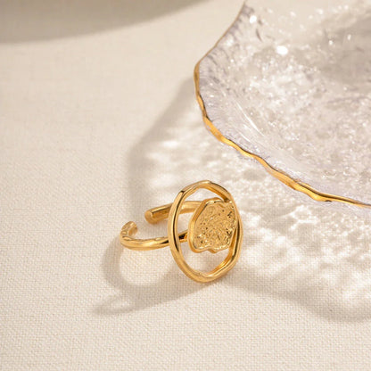 Elegant 18K gold-plated stainless steel ring with intricate hollow-carved design and vintage-inspired charm
