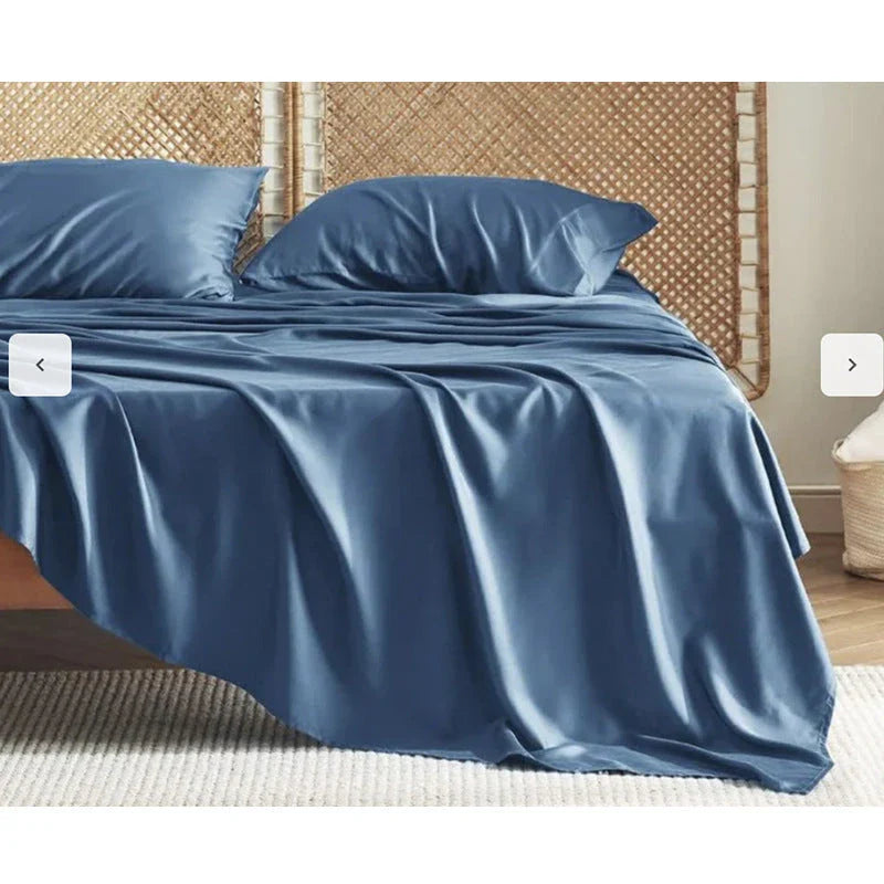 Premium bamboo fibre bed sheets in a classic solid purplish blue colour, featuring a four-piece set including a fitted sheet, flat sheet, and two pillowcases.