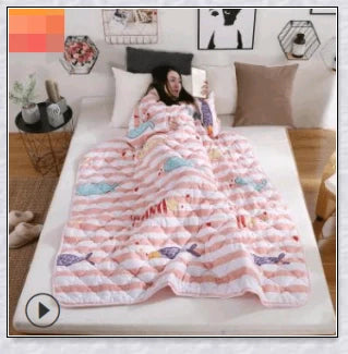 A cosy, wearable quilt with sleeves in a variety of colourful designs, perfect for staying warm and comfortable during the winter months.