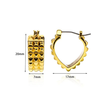 A pair of gold-toned stainless steel hoop earrings, showcasing a classic and sophisticated design