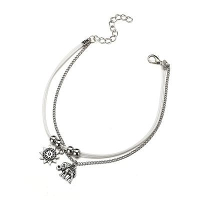Elegant bohemian-style anklet with star and elephant charms in shimmering gold and silver tones