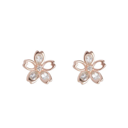 Pair of elegant zircon cherry blossom earrings in skin colour, featuring a delicate floral design and sparkling stones
