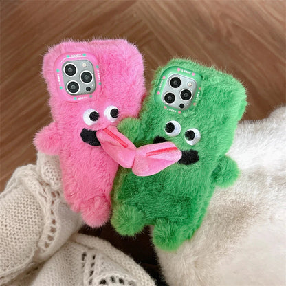 Playful plush phone case with cheeky cartoon monster in pink or green, offering shock-absorbing protection for iPhone models