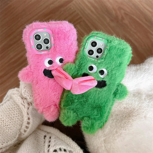Playful plush phone case with cheeky cartoon monster in pink or green, offering shock-absorbing protection for iPhone models