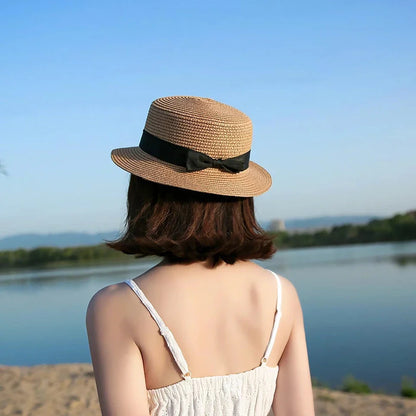 A classic summer Panama hat made from straw and paper, featuring a charming bow detail that adds a feminine touch.