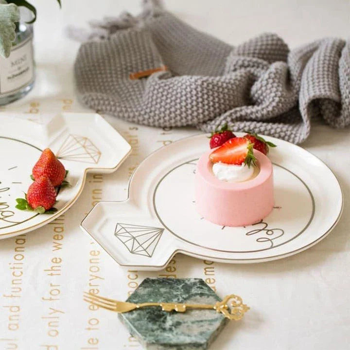Elegant diamond ring-inspired porcelain dinnerware set with plate, bowl, and cup in a minimalist white colour