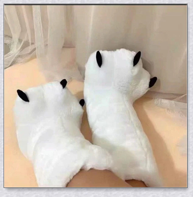 Cosy and whimsical oversized bear paw winter slippers with a plush, fluffy design and non-slip sole for secure indoor wear