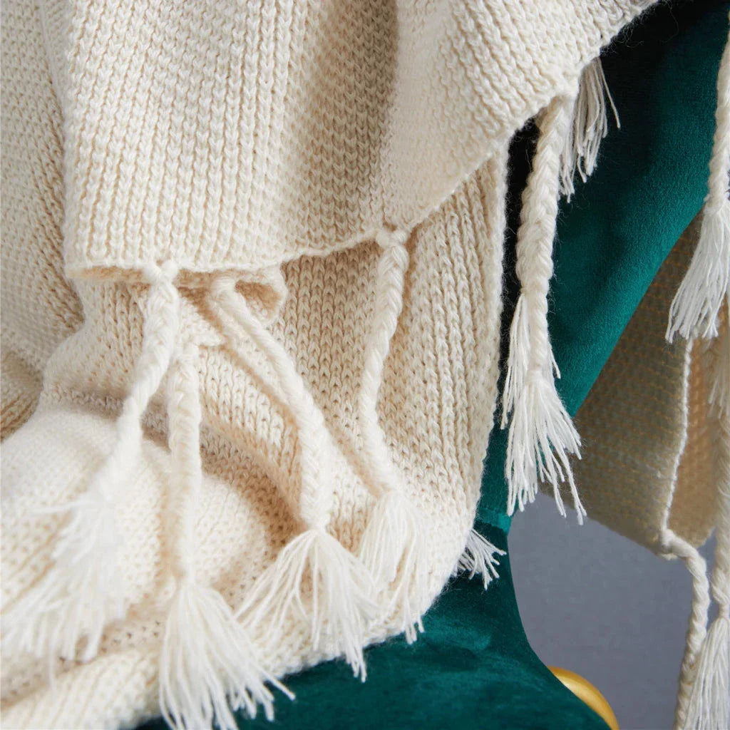 Luxurious Nordic-style wool knitted throw blanket in grey colour, featuring a solid pattern and elegant tassel design