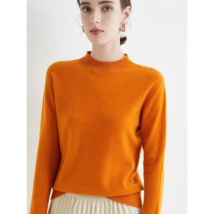 A woman wearing a luxurious Merino wool mock-neck jumper in a stylish autumnal outfit