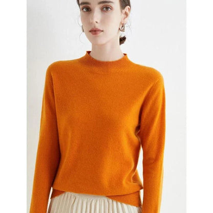 A woman wearing a luxurious Merino wool mock-neck jumper in a stylish autumnal outfit