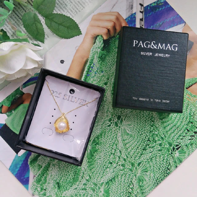 Elegant pearl pendant necklace with sterling silver setting, featuring a modern geometric design
