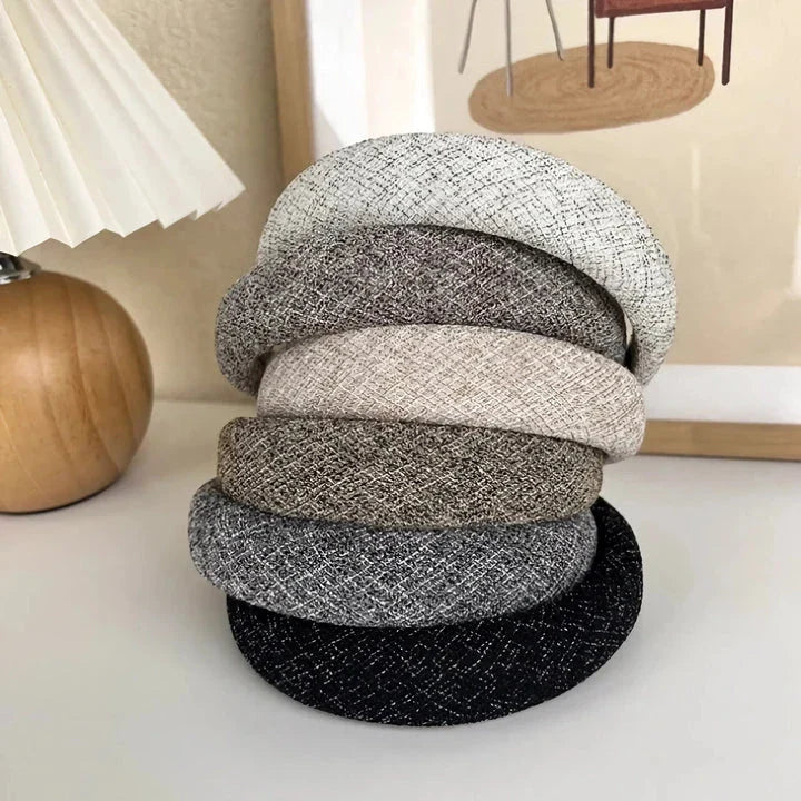 A stylish wide hairband in a classic plaid pattern, offering a chic and sophisticated look for British women.