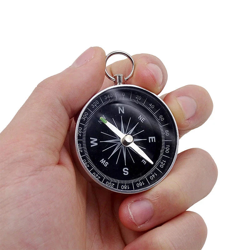 Compact aluminium compass keychain with tempered glass surface and bright compass face, perfect for outdoor adventures in the UK