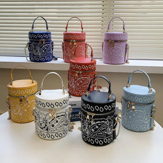 Premium PU leather bucket bag in a variety of classic and contemporary colours, featuring a spacious main compartment, adjustable shoulder strap, and sophisticated British-inspired design.