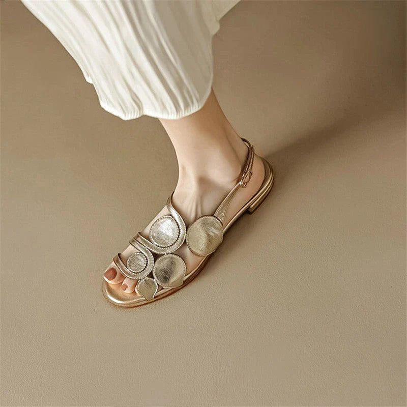 Chic sheepskin round toe sandals with a chunky heel and hollow out design, featuring a secure back strap and a modern, versatile style