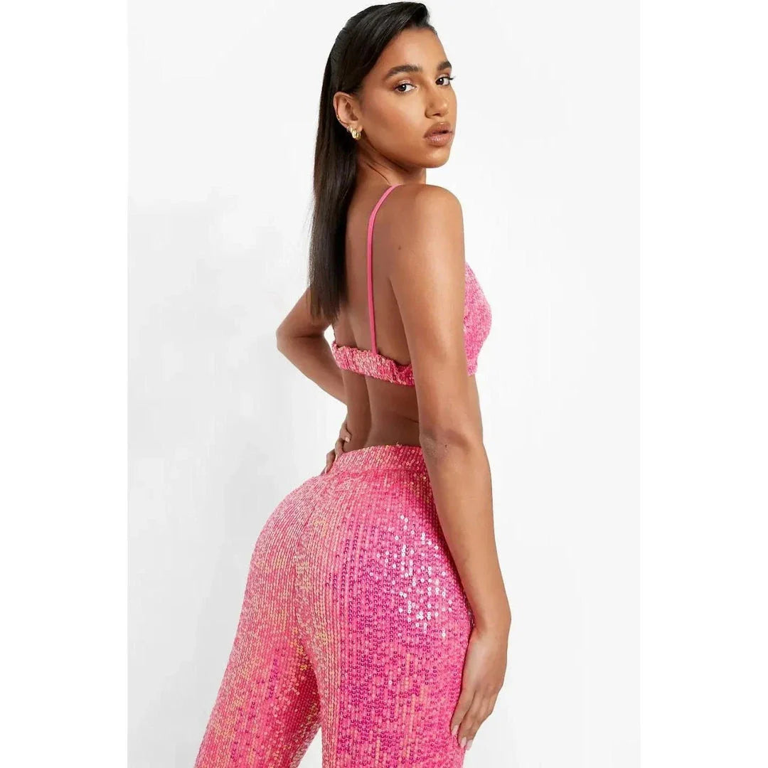 Elegant woman wearing a luxurious sequin top and pants set, perfect for a glamorous evening event