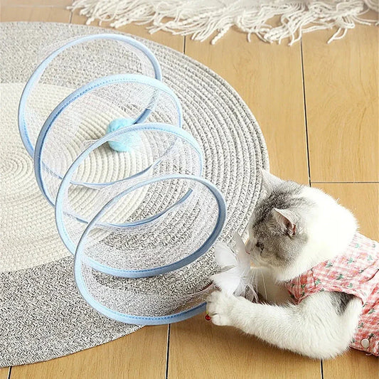 Folding cat play tunnel with various toys like balls, feathers, and mice attached to the sides