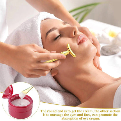 A rose gold metal eye cream applicator and face massager tool with a Y-shaped design for effective skincare application and facial massage