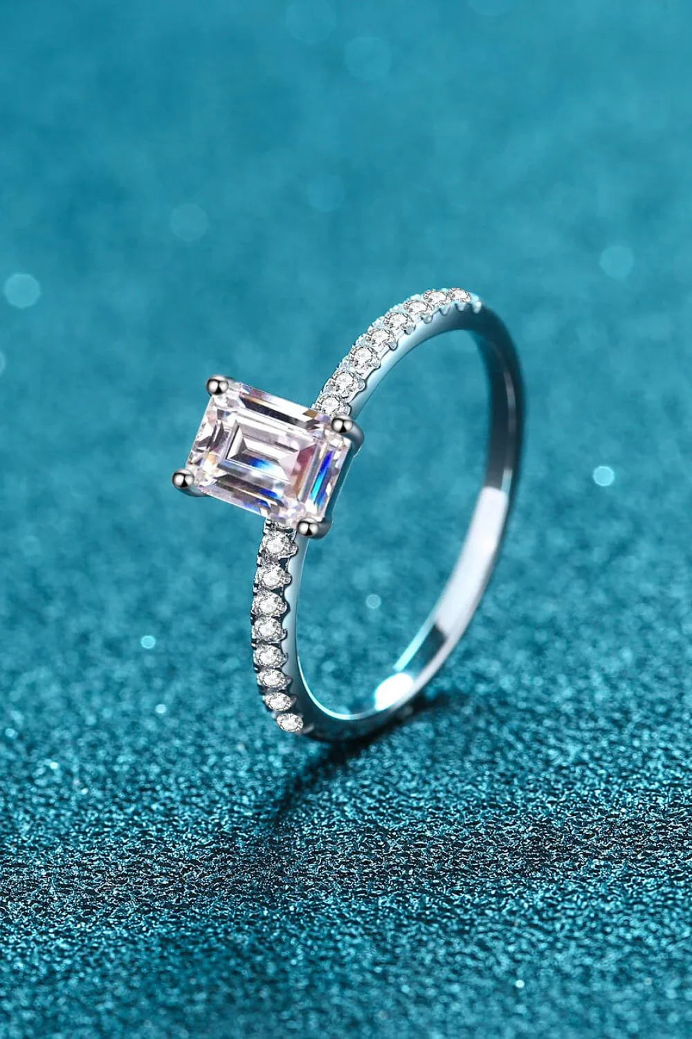 Exquisite 925 sterling silver ring with a radiant moissanite centre stone, accented with sparkling zircon stones for added elegance.