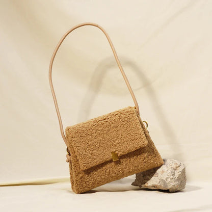 A stylish faux lamb wool crossbody bag in beige, black, or khaki brown with a contemporary design and practical storage features