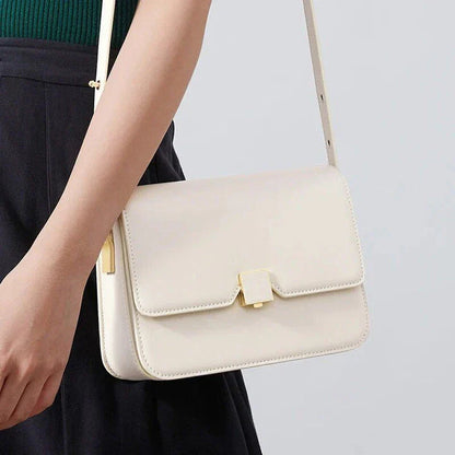 Stylish British-inspired leather shoulder and crossbody bag in black, tan, and navy colours