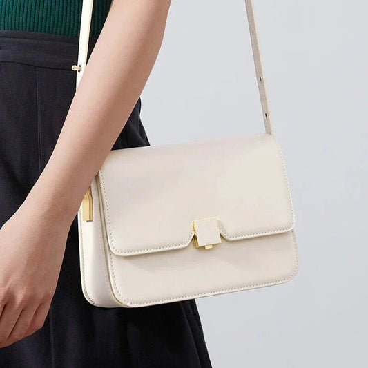 Stylish British-inspired leather shoulder and crossbody bag in black, tan, and navy colours